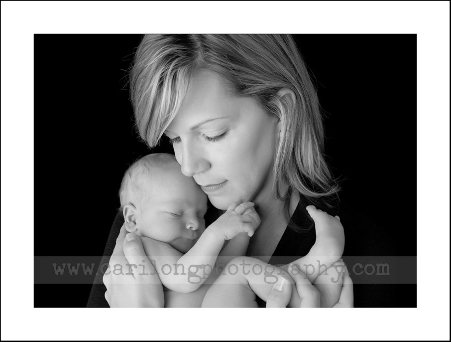 A lovely image of a newborn baby boy and his mother. Photographed in our studio in Cary, NC.
