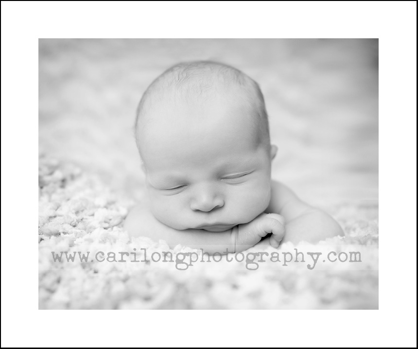 This newborn baby boy is so sleepy and sweet. Cari long is a photographer is raleigh, NC.