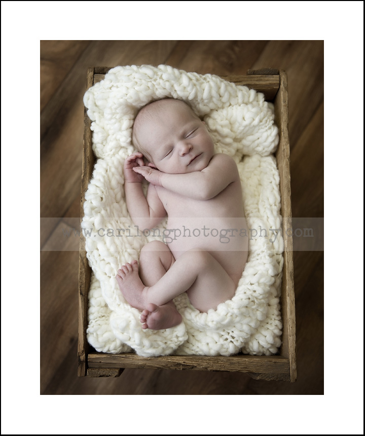 We photographed this sweet newborn baby in a blanket fillled pepsi crate.